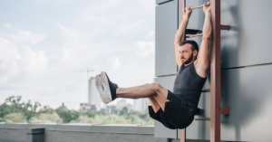 man performing hanging leg raises