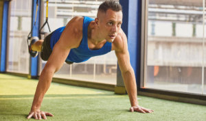 man performing TRX avoid holiday weight gain