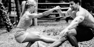 man and woman performing a pistol squat