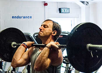 man struggling with weights gain muscle fast